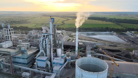 aerial view of cement factory with high concrete plant structure and tower crane at industrial production area. manufacture and global industry concept