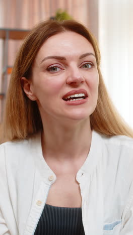 woman waving cheerfully during video call at home speaking with joy hosting online pov conversation