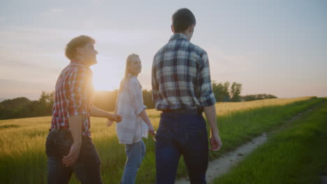 three friends walking during golden sunset