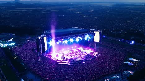 a large crowd gathers for a concert at an outdoor stadium