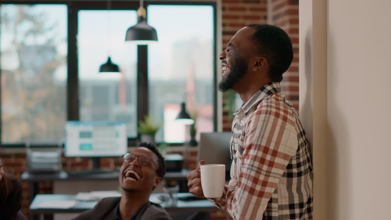 African american man laughing and talking to job colleagues
