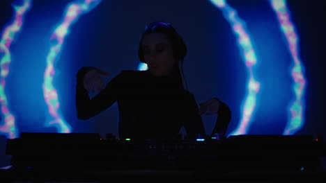 female dj mixing music in a nightclub