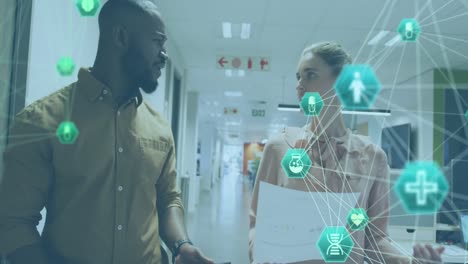 animation of connected icons globes, diverse coworkers discussing reports while walking in office