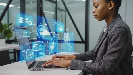 Woman working with futuristic holographic data interface on laptop
