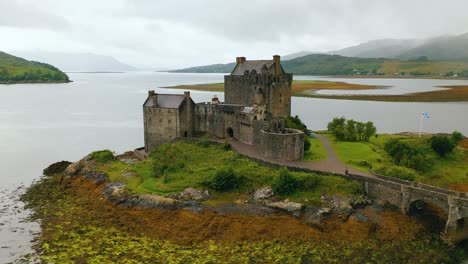 Eilean-Donan-Castle-in-Scotland-at-cloudy-sunrise-on-low-tide,-UK---Historic-Castle-near-Isle-of-Skye