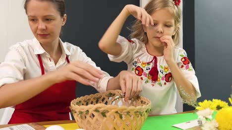 mother and daughter creating an easter basket