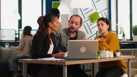 enthusiastic concentrated business colleagues discussing holding documents