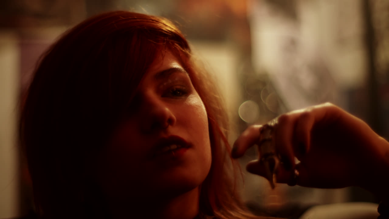 Close-up portrait of a woman in a dimly lit room