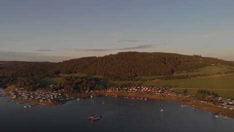 a-professional-looking-aerial-fyling-towards-a-small-hill-while-warm-sunset-in-bavaria-germany