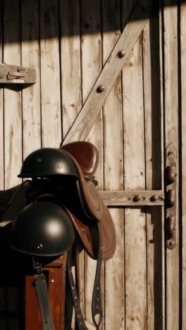 close-up of a brown leather horse saddle and riding helmet