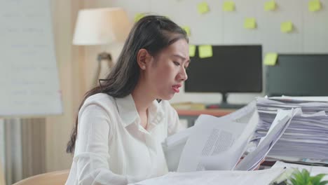 close up of pressure asian woman throw away the paper while working hard with documents at the office