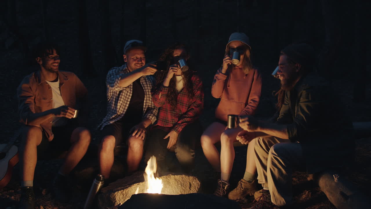Friends enjoying a campfire in the woods