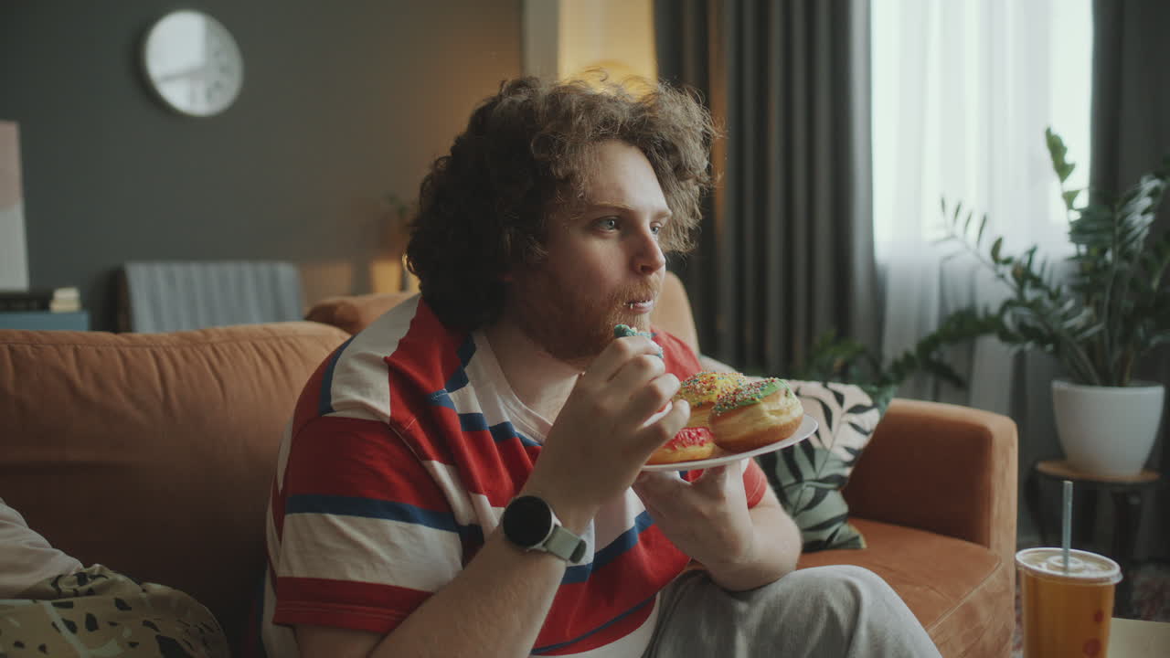 Man Eating Donuts at Home
