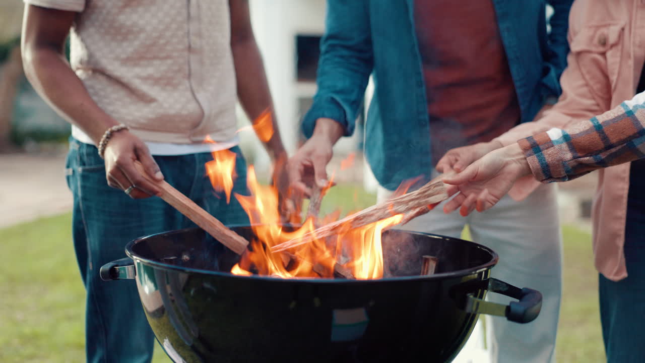 People gathered around a barbecue grill with fire