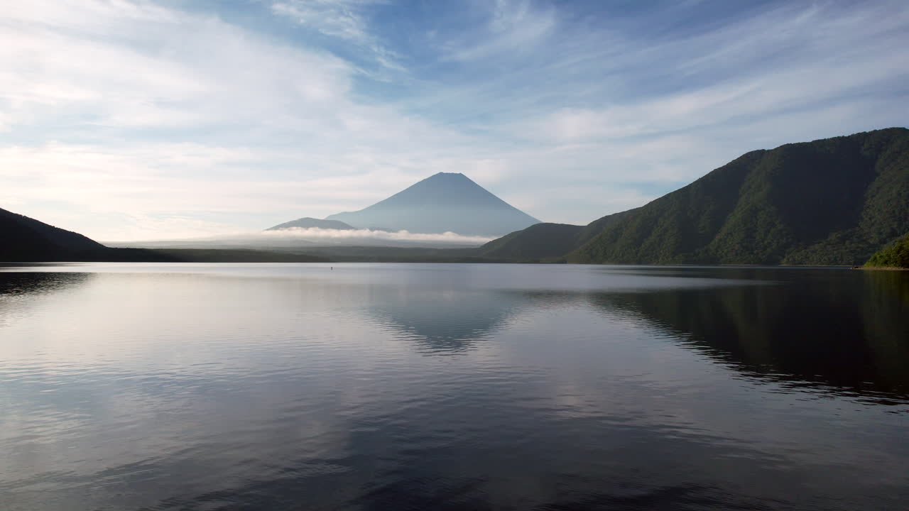 Soaring drone captures Mount Fuji's mirrored beauty over Lake Motosu's tranquil expanse