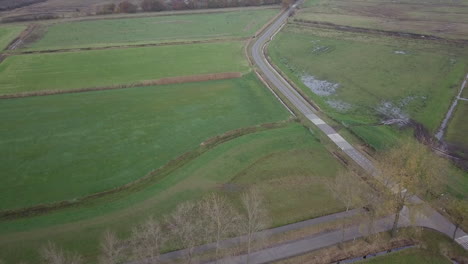 Aerial-drone-shot-of-flyover-the-countryside-road-in-the-Netherlands