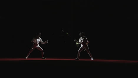 two fencers compete in a match, one with a raised sword and the other in a defensive stance