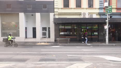 people walking and vehicles passing by