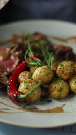 appetizing steak dinner with roasted potatoes