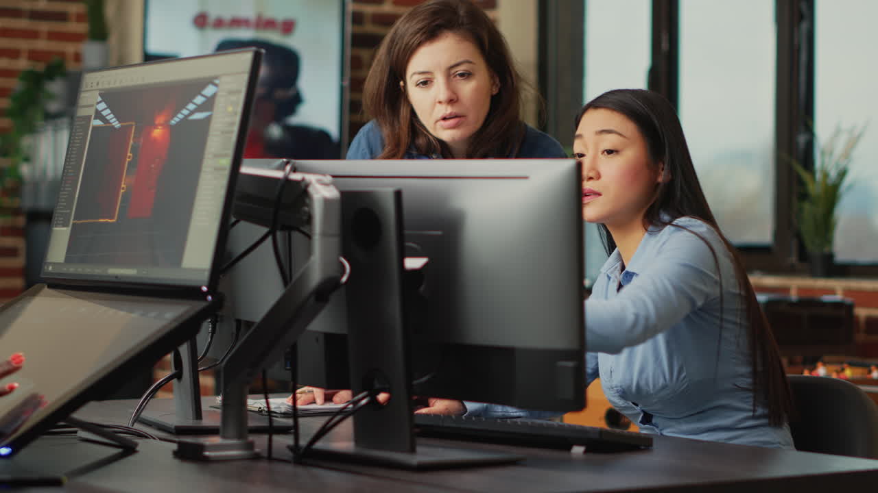 Diverse team of employees analyzing project component on multi screens