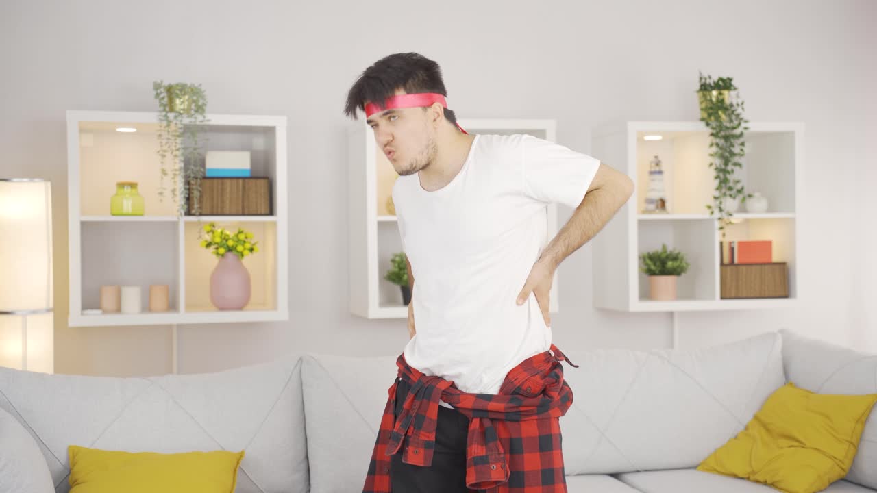 Funny man injures his back by doing wrong sports.