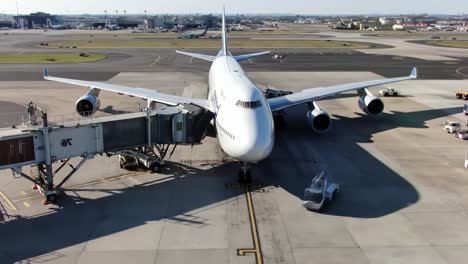 a stunning view of a large passenger airplane at the airport gate during ground operations, showcasing aircraft maintenance and preparation for departure