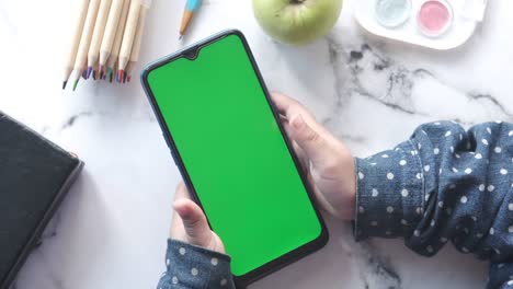 flat composition of child girl using smart phone on table