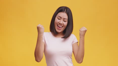 excited asian woman celebrating