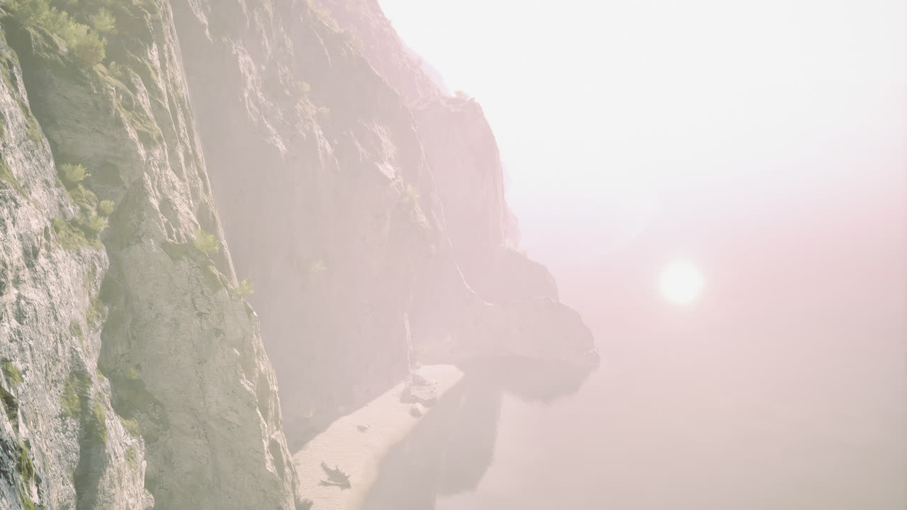 Scenic coastal cliffs overlooking tranquil waters at sunset near a serene beach