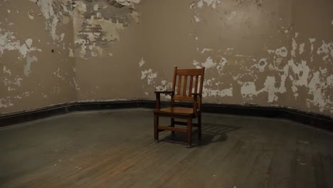 lone chair sitting in room with peeling paint showing loneliness and depression