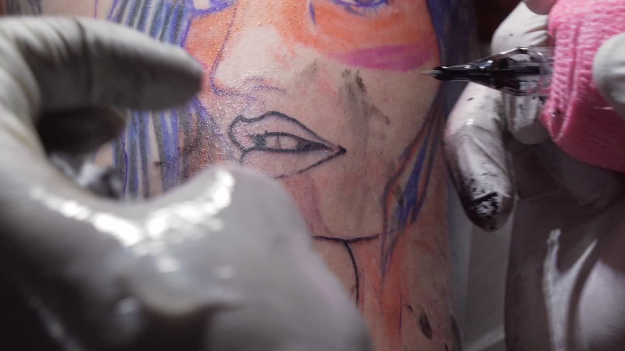 Tattoo artist applying vaseline gel after tattooing, professional work, close-up view