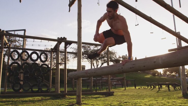 Young man training at an outdoor gym bootcamp