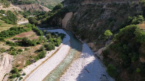 Wild-river-of-Vjosa-streaming-through-cliffs-of-beautiful-valley-on-a-remote-mountain-area-in-Albania