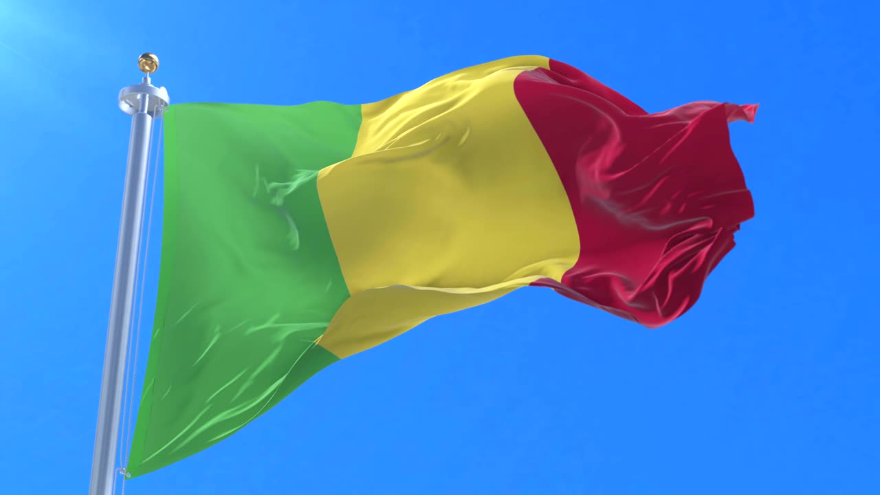 Flag of Mali waving at wind with blue sky in slow, loop
