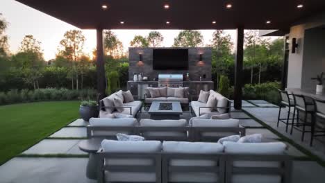 elegant outdoor living space featuring a relaxing pool and stylish lounge area with modern amenities, perfect for gatherings at sunset