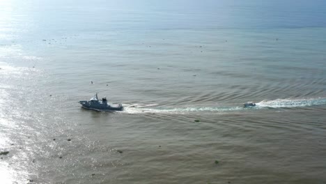 Armed-ship-navigating-at-sunrise-on-Caribbean-sea,-Santo-Domingo-in-Dominican-Republic