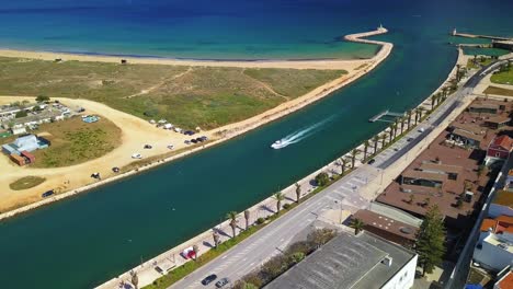 Aerial-shot-of-a-boat-in-lagos,-portugal-with-birds-flying-around-it-in-4k