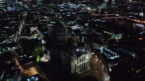 Orbit-shot-around-modestly-illuminated-Saint-Pauls-Cathedral-on--Ludgate-Hill.-Aerial-view-of-night-cityscape.-London,-UK