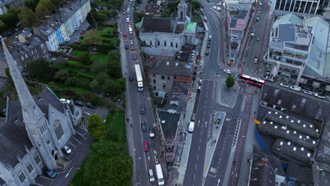 downtown street traffic and buildings in cork city, ireland - aerial drone shot