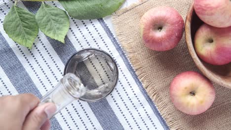 pouring apple cider vinegar into a glass