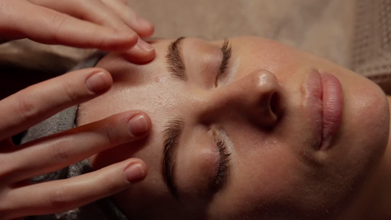 Close-Up of Woman Receiving Relaxing Facial Massage at Spa