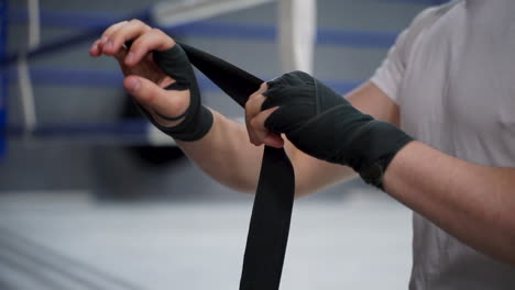 close up of hand wrapping with boxing bandages before training