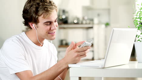 young man listening to music at home