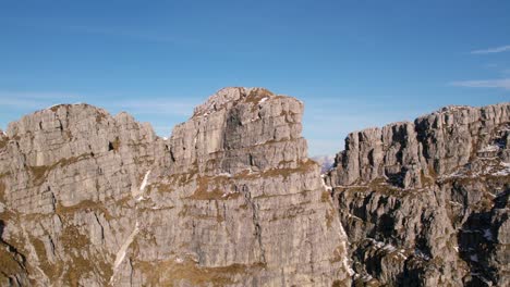 aerial drone panning view of resegone mountain and rifugio azzoni refuge of italian alps in northern italy