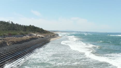 tottori coastline, aerial flying across the waves of sea of japan