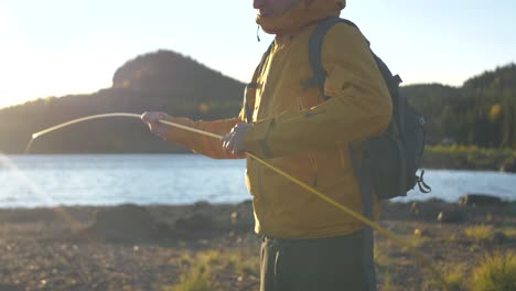 connecting tent poles with each other to assemble tent in sweden wild - medium close up slow-motion shot