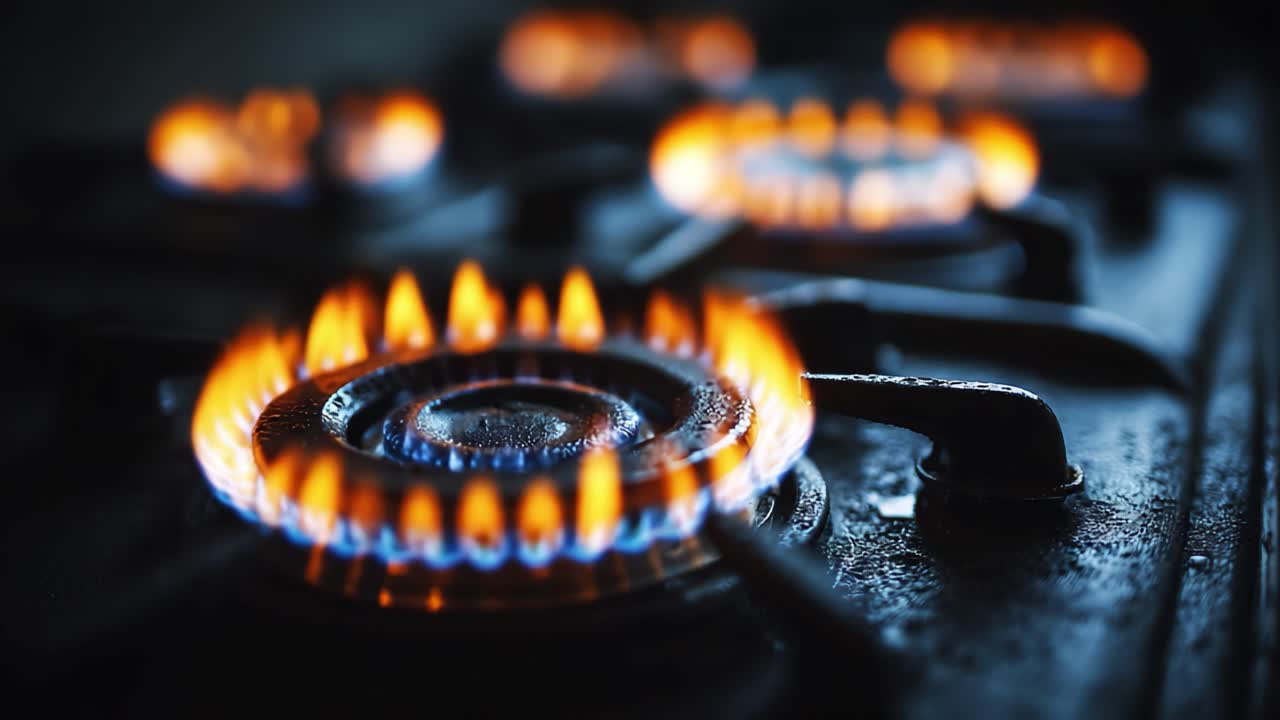 Intense Flames Dancing on a Gas Stove: Captivating Close-Up of Cooking Flames and Burners in Action, Highlighting the Beauty of Fire in the Kitchen Environment
