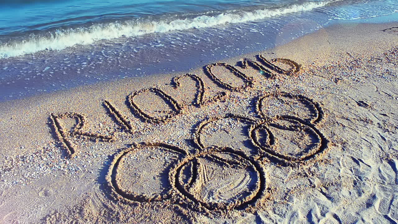 Rio 2016 an inscription on sand, the beach. Symbol Olympic game on sand, the beach
