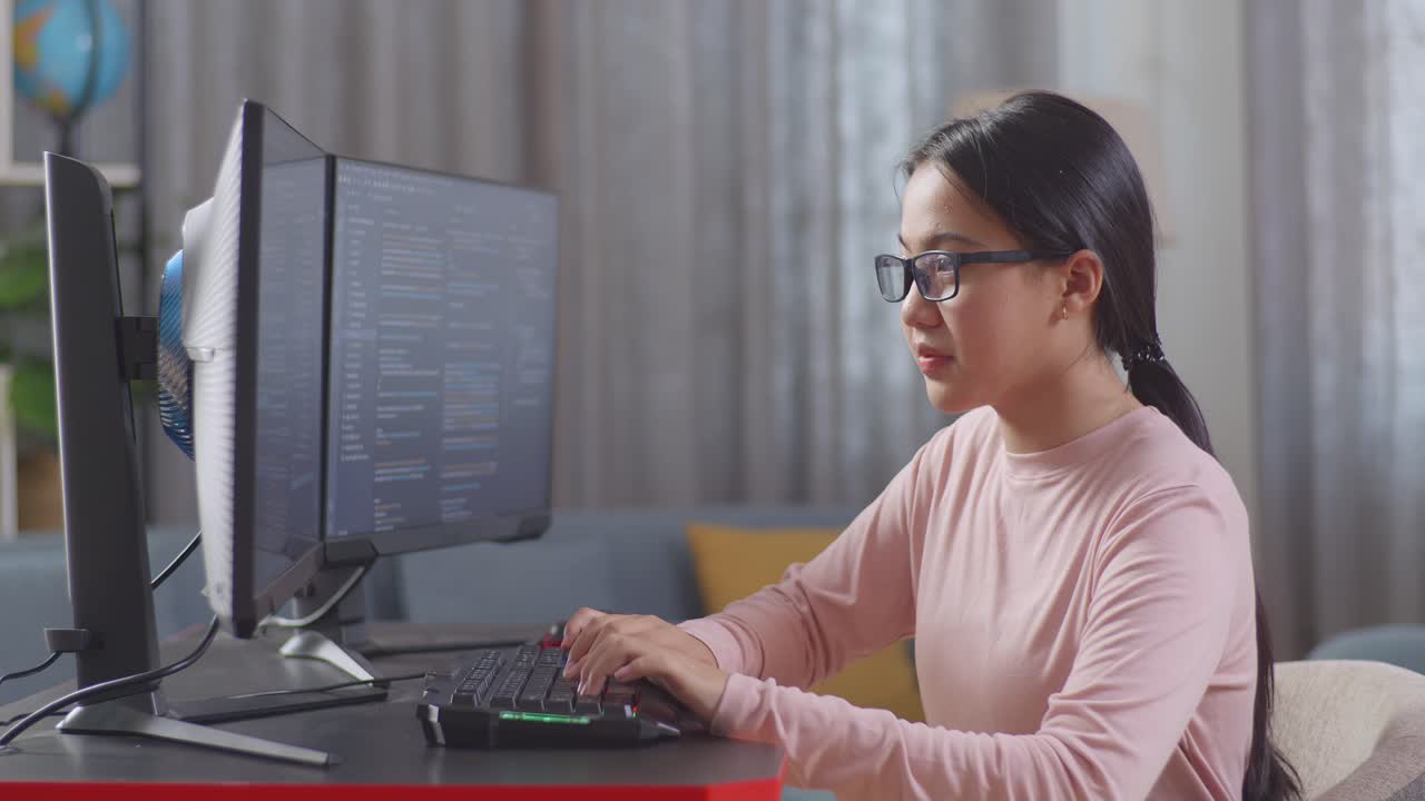 Asian Teen Girl Programmer Creating Innovative Software Engineer Developing App, Program, Video Game On Desktop Computer At Home. Terminal With Coding Language
