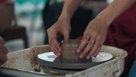 pottery class - shaping clay on a wheel